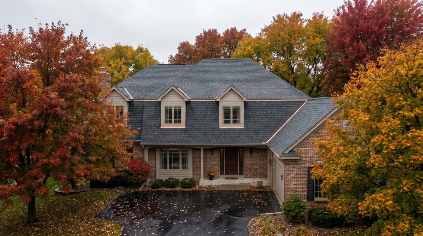 Brainerd two-story home on a wooded street with new GAF Timberline HDZ in charcoal, 8/12 pitch, October color