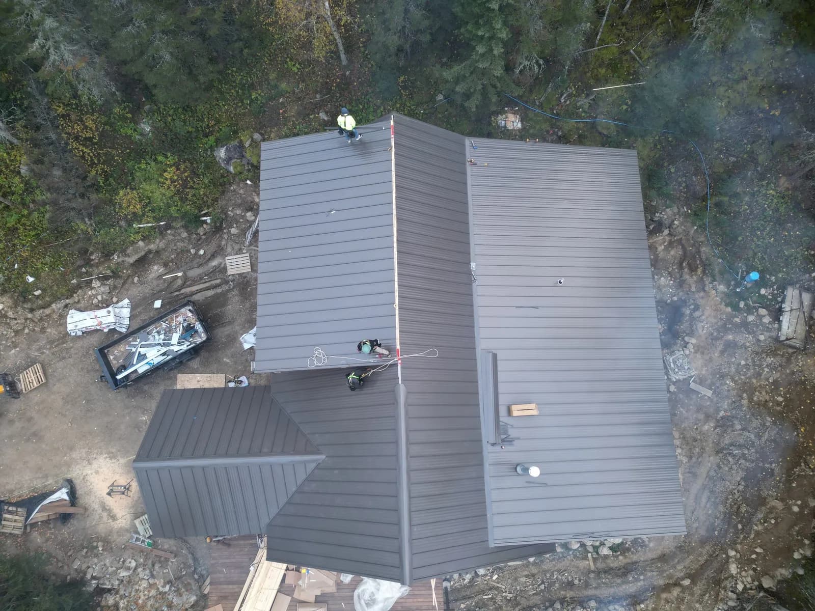Sample project page photo, Day 1: standing seam metal roof on a timber lodge