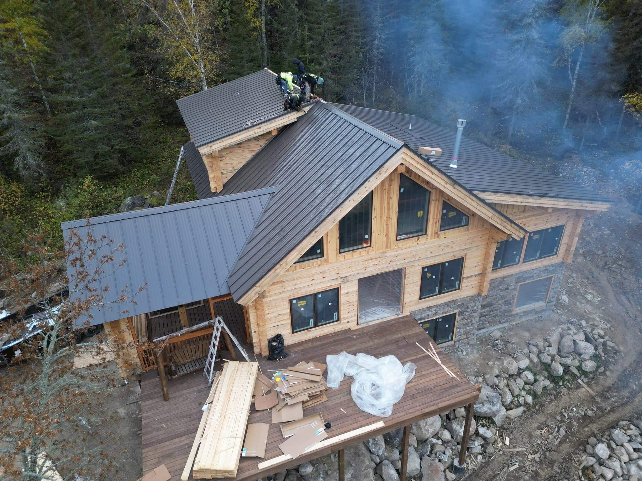 Standing seam metal roof on a log lodge by a lake in Crane Lake, photo 1 of 4